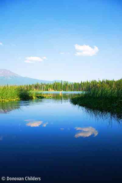 Smooth water at Hosmer Lake with sky reflection